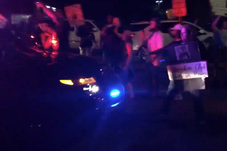 A demonstrator at a Stephon Clark vigil reacts as a Sacramento County Sheriff's vehicle approaches in Sacramento, California on March 31, 2018 in this still image obtained from social media video April 1, 2018.
